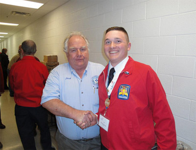 Photo 5. Residential Gold Medal. Jack Jamison proudly shakes the hand of the Gold Medalist for the residential wiring section of SkillsUSA WV.