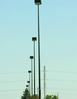 Photo 4. The parking lot luminaires shown here were supplied by load-side branch circuits that did not include an equipment grounding conductor. The installers thought that a ground rod installed adjacent to each pole would accommodate the problem.