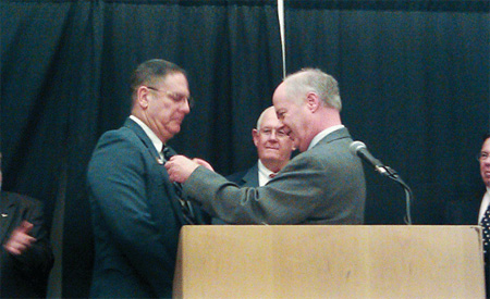 Photo 2. Chuck Mello, International President of IAEI, receives the Gold Roadrunner award presented by 2009 recipient Mark Earley, NFPA, at the 2011 Southern Section meeting in Chattanooga, Tennessee.