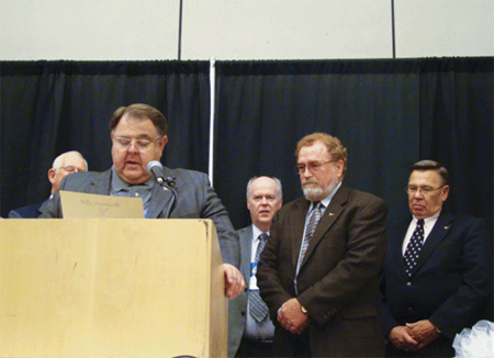 Photo 3. John Minick inducts Mark Ode into the Roadrunner Club.