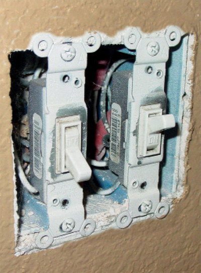 Photo 1. Switch boxes installed in noncombustible material such as gypsum are allowed to be flush or up to a 6 mm (1/4 in.) setback.
