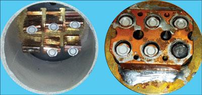 Photo 3. This is a photo showing the interior of a 600-amp fuse after the sand filler has been removed. This fuse opened during an overload condition. You can see how five of the six alloy contact points melted and released; when the last one interrupted the flow of current, it arced and caused the burned sixth contact. Please note in the left photo you can see the short-circuit elements which are still intact; these are the webs which melt out during a high fault current condition.