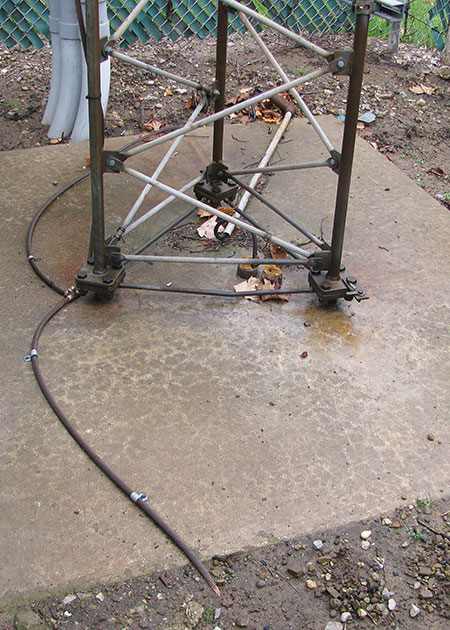 Figure 6. The base of the antenna tower is shown here after the upgrade. The tower had originally been fitted with two grounding rods, but the rods had corroded unevenly, giving rise to a difference in their ground impedances. During the 2013 strike, lightning energy would have favored the lower-impedance rod, setting up a massive ground loop current in a circuit that included the interior grounding bar and the improperly grounded equipment racks.