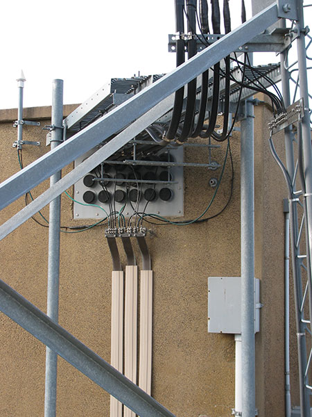 Figure 8. When lightning strikes one of the nine auxiliary sites that the county operates, energy is bled off the coax on the vertical run, the coax where it penetrates the firewall, and the interior side of the firewall.
