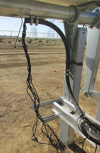 Photo 9. Single string conductors emerge from radiator hose/multiconductor cable assembly with no equipment grounding conductor; conductor type markings are also absent.