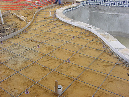 Photo 3. Perimeter surface consisting of conductive structural metal reinforcement steel (rebar). Notice the structural steel from the conductive pool shell (belly steel) bent over and tied to the perimeter surface (deck steel).