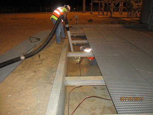 Photo 3D. Using a vacuum-truck to remove the sand that migrated from a 50 MW portion of the site.