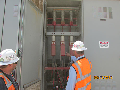 Photo 4A. Operators identifying major amounts of sand & dust that have migrated into the 35 kV breaker cubicles.