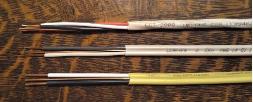 Photo 5. Three Non-metallic Sheathed Cables (NMSC) Top 3 #14AWG insulated conductors with a bare bond conductor NMSC; Middle 2 #14AWG insulated conductors with a bare bond conductor NMSC; and Bottom 2 #12AWG insulated conductors with a bare bond conductor NMSC.