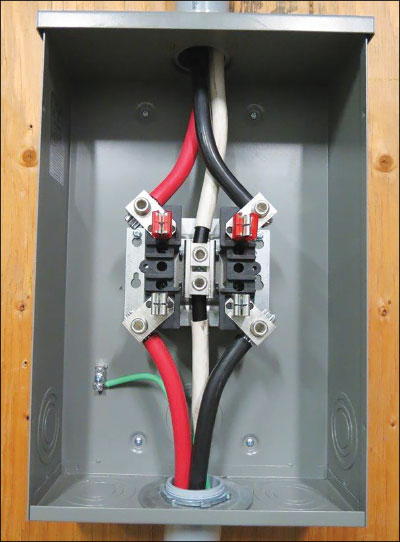Photo 1. The picture of a meter base with neutral connected to the enclosures. The requirement to limit the system grounding to one location will now require the grounding conductor to terminate in the meterbase, the bond jumper (bonding screw) in the service box to be removed and a bond conductor between the meterbase and the service box. NOTE: This meter mounting device does not have provisions for connection of a grounding conductor. Courtesy of MD Electric