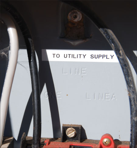 Photo 6. Note the factory embossed “LINE” marking on this unfused ac disconnect (safety switch) just below the word “UTILITY” on the field-installed label. OK for backfeeding with the utility connection to the line terminals.