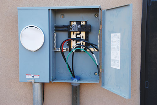 Photo 4. Meter-Main Combo panelboard being installed. Do not allow a supply-side connection to the easily accessible conductors between the meter and the main breaker.