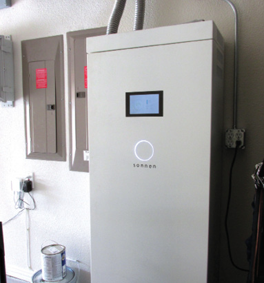 An energy storage system consisting of batteries installed at a single-family dwelling inside a garage.
