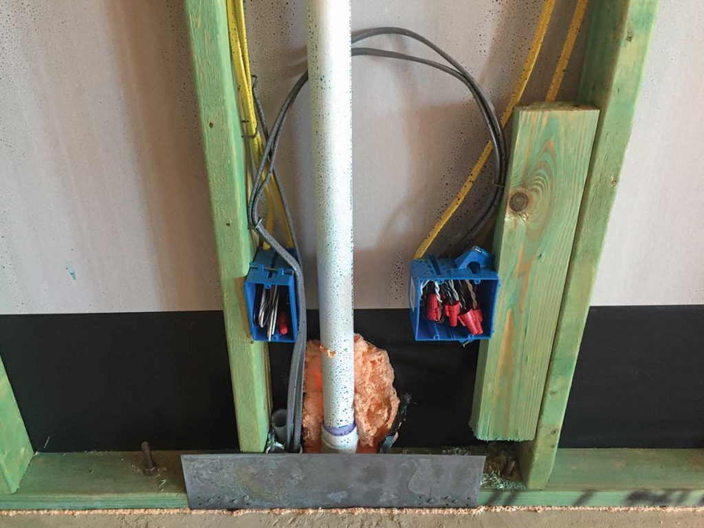Photo 6. The rough-in stage of Type UF cable installed in a PVC raceway under a concrete slab to a kitchen island location. 