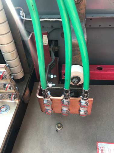 Photo 5. Equipment grounding conductor cables terminated to the grounding bus of the switchgear.