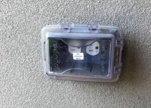Photo 2a. A receptacle outlet located in a wet location with the appropriate cover and marked as having GFCI protection.