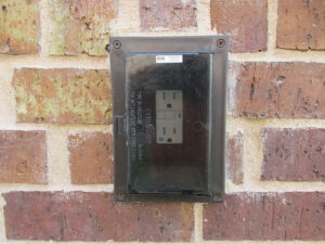 Photo 2c. A wet location cover with the receptacle marked weather-resistant (WR).
