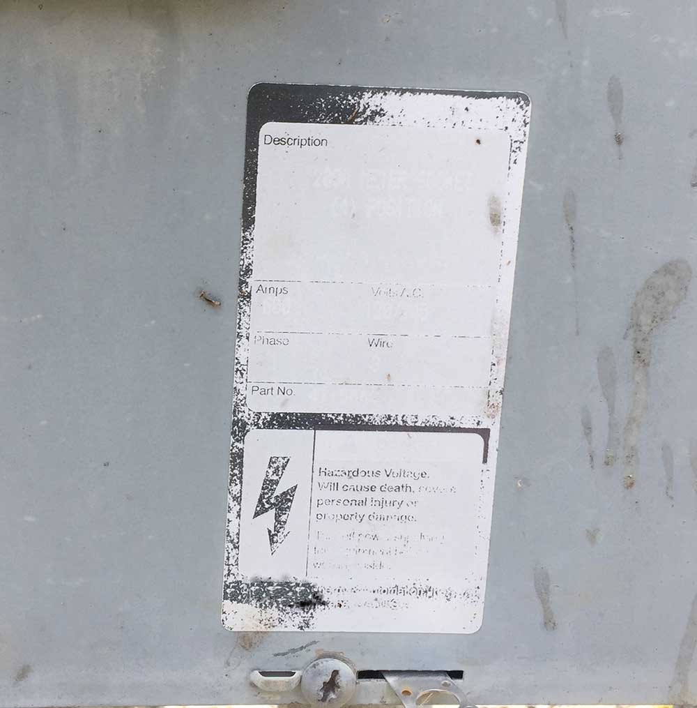Photo 1. Faded nameplate on equipment