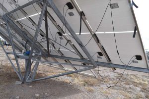 Photo 4. Fifteen-year-old PV system with module cables dangling due to deteriorated and missing plastic wire ties.  Courtesy of John Wiles